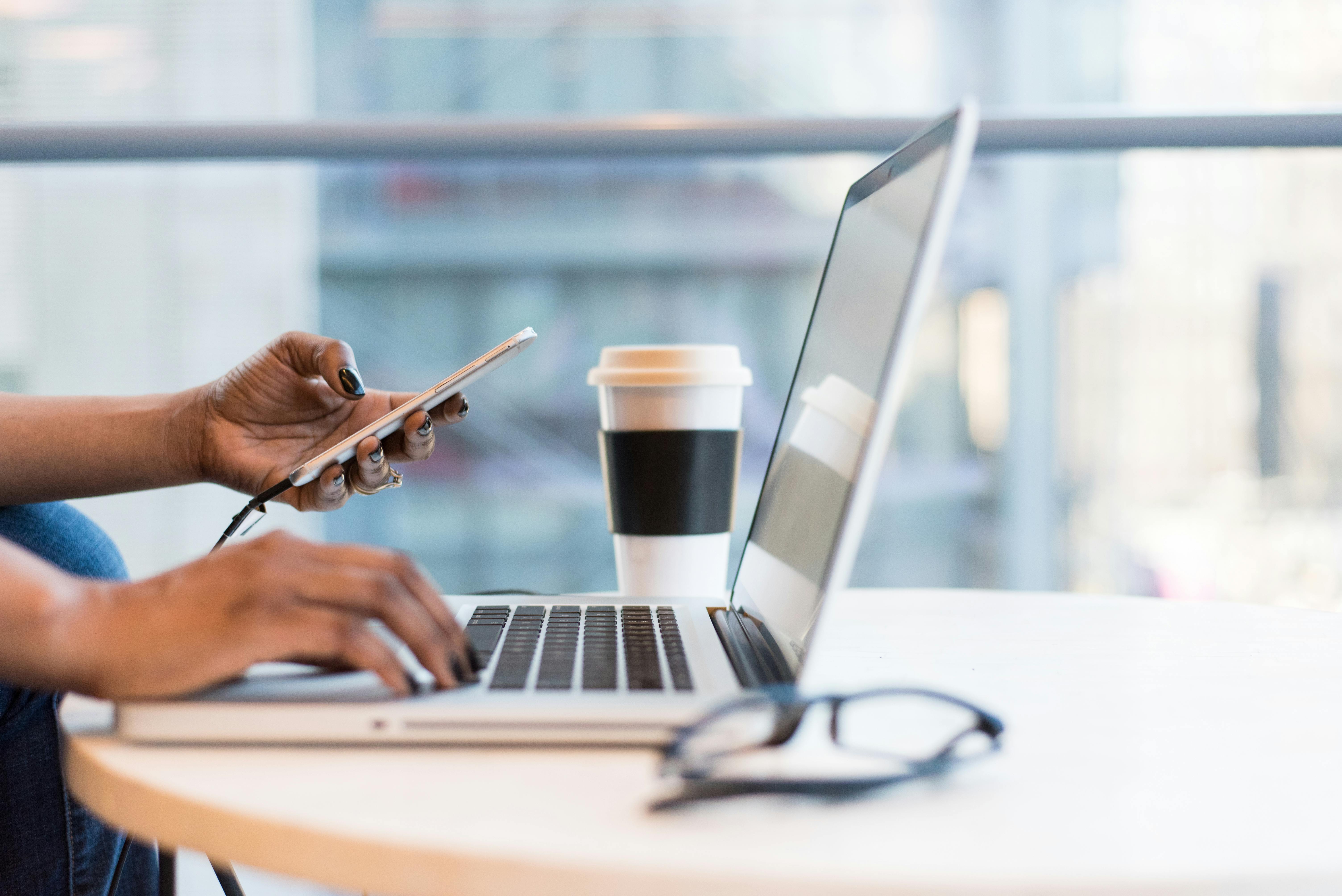 Person on computer and phone